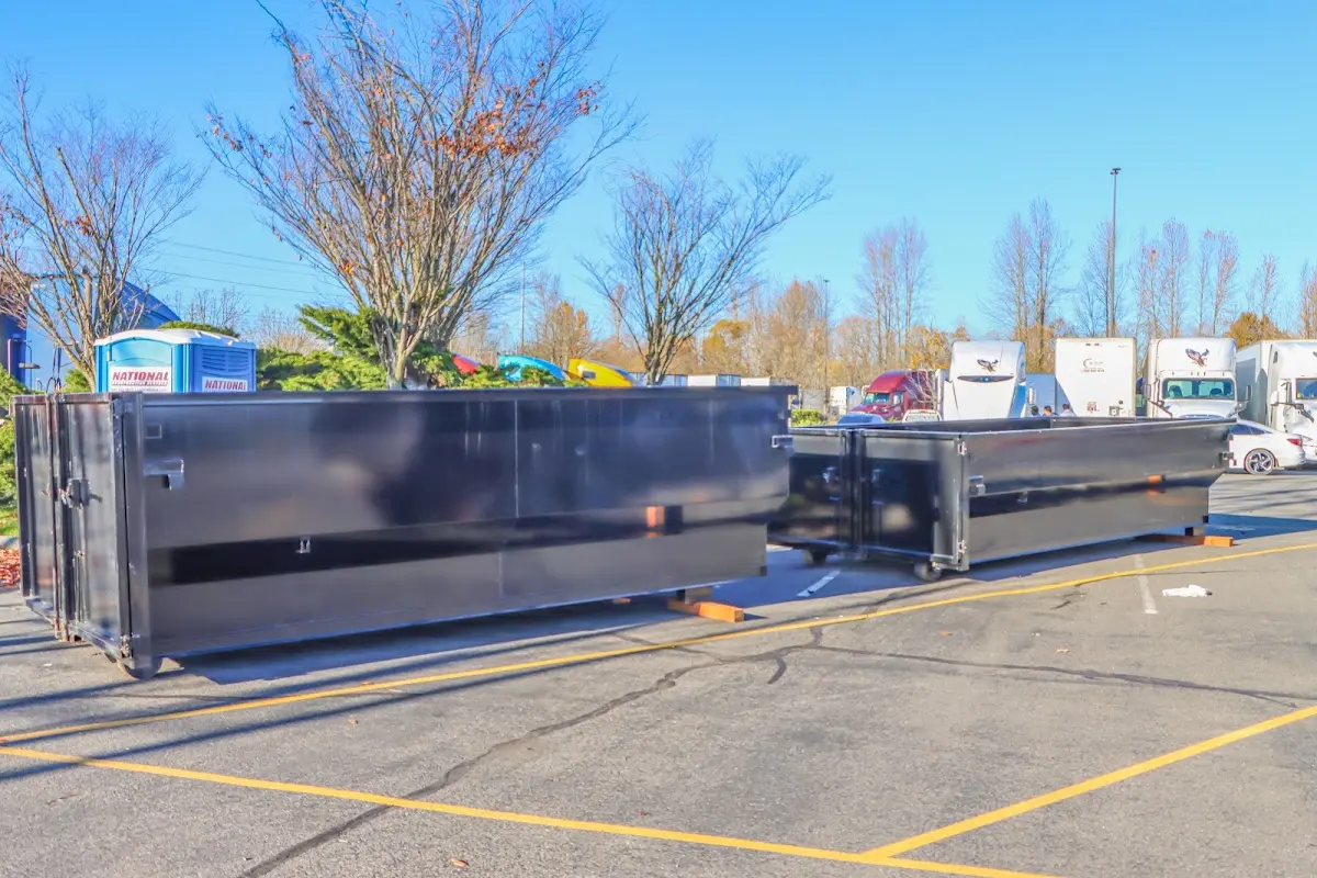 Professional dumpster rental service with roll-off container on residential driveway in Merrifield